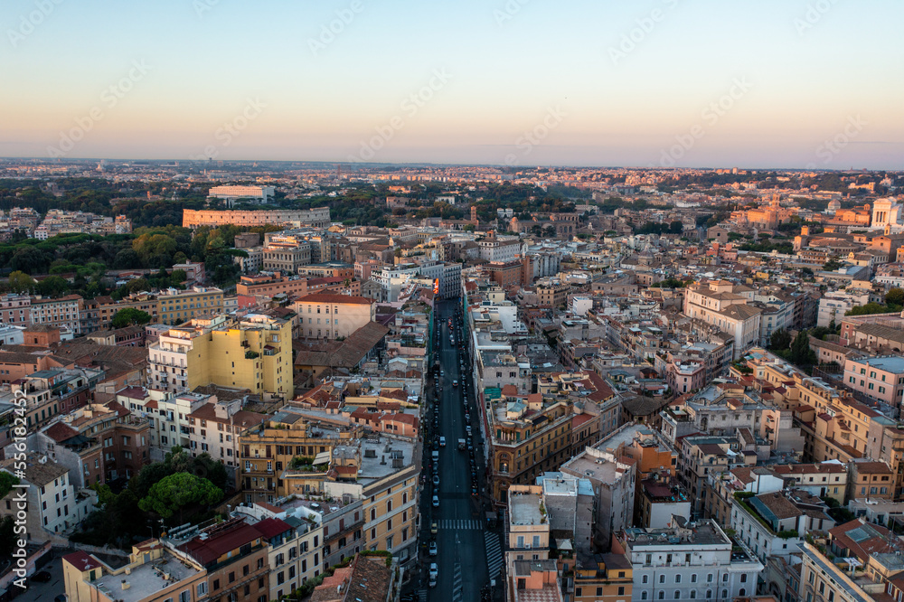 Aerial View of a Wide Avenue Looking Towards the Coliseum and Forum in Rome at Sunrise