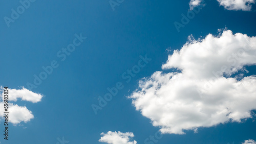 White fluffy clouds with blue sky background