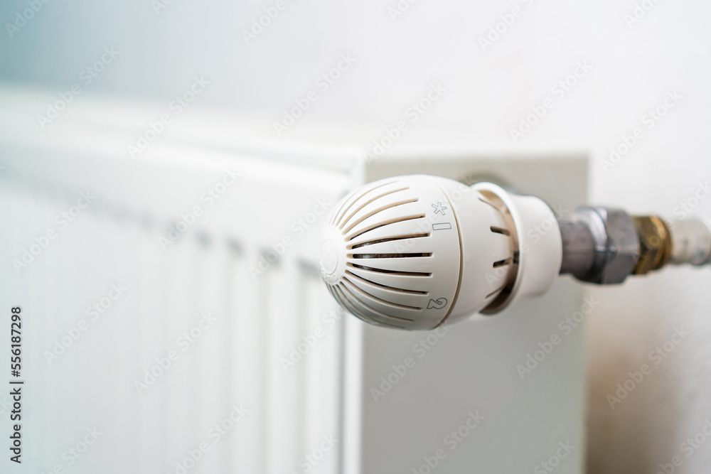 Faucet or temperature regulator on the radiator of the heating system, selective focus. Background Faucet or temperature regulator on the radiator of the heating system, selective focus. Background