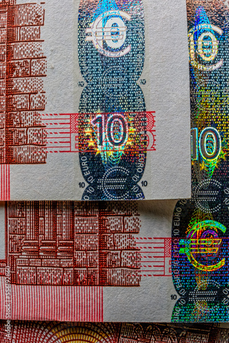 closeup of European currency seal, with hologram and other security features visible. seal designed to be tamper-proof. hologram extra layer of authenticity, as reflects light in distinctive pattern
