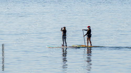 People are enjoying stand up paddle boarding © Yan