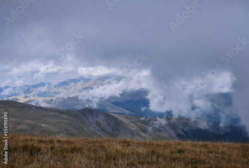 Mountain landscape. Beautiful sunny day in the mountains. Low clouds in mountains Carpathian mountains in Romania