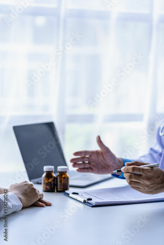 Wallpaper Mural Doctor talking to patient in clinic office Female patient sitting in medical chair while explaining to doctor about health problem at hospital, consultant concept Torontodigital.ca
