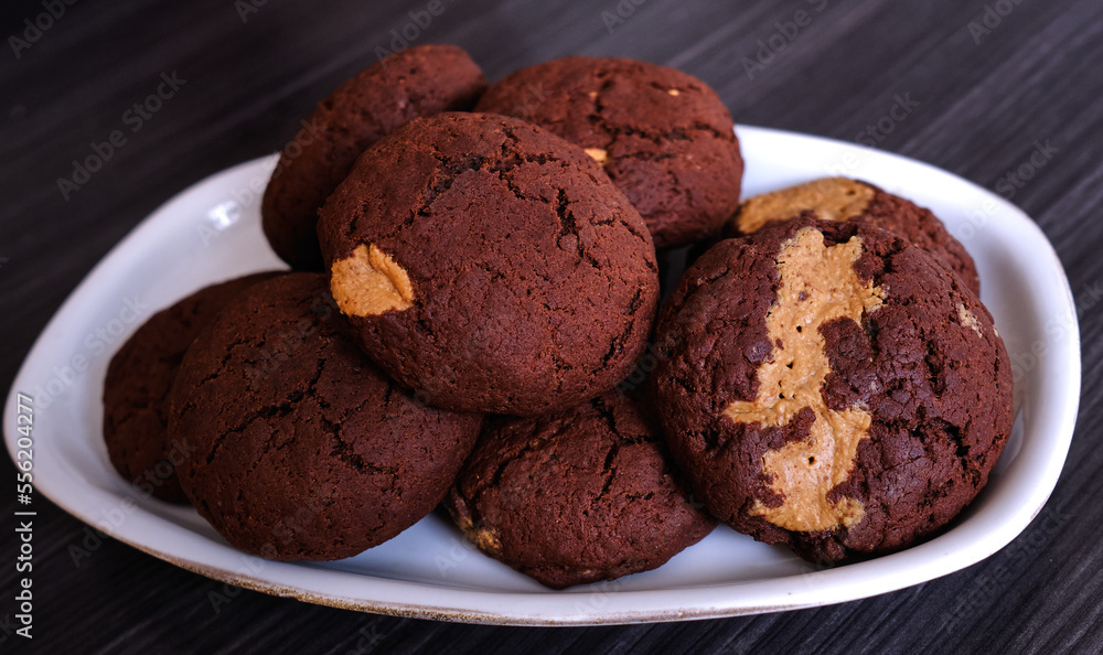Chocolate cookies with peanut butter on a dark background Chocolate cookies with peanut butter on a dark background