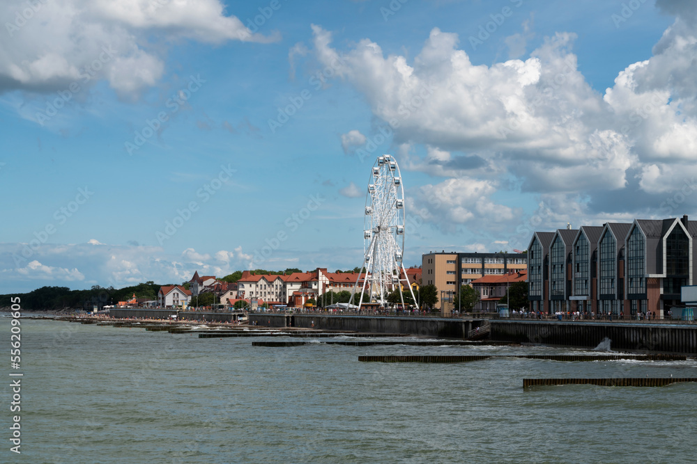 View of the promenade of the resort town and the Ferris wheel on a sunny summer day, Zelenogradsk, Kaliningrad region, Russia View of the promenade of the resort town and the Ferris wheel on a sunny summer day, Zelenogradsk, Kaliningrad region, Russia