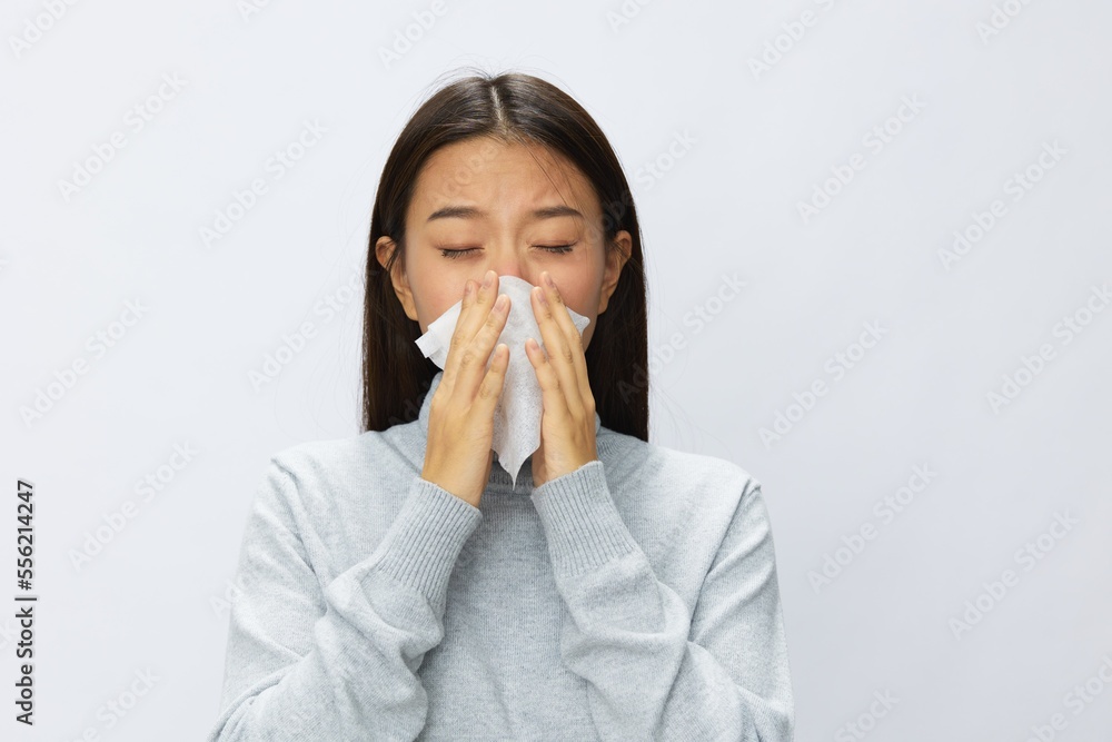 Asian woman holding hand with handkerchief and coughing up flu and cold, stuffy nose viral disease covid 19 white background Asian woman holding hand with handkerchief and coughing up flu and cold, stuffy nose viral disease covid 19 white background