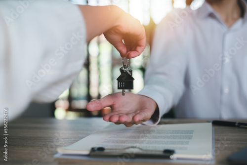 keys in the hand of a real estate agent,Investment loan approval concepts to build residential homes, real estate business, investment savings, mortgages and bank loans, future retirement planning.