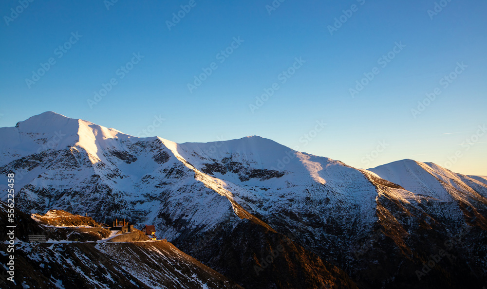 Landscape with golden hour light on the snow on the Fagaras mountains