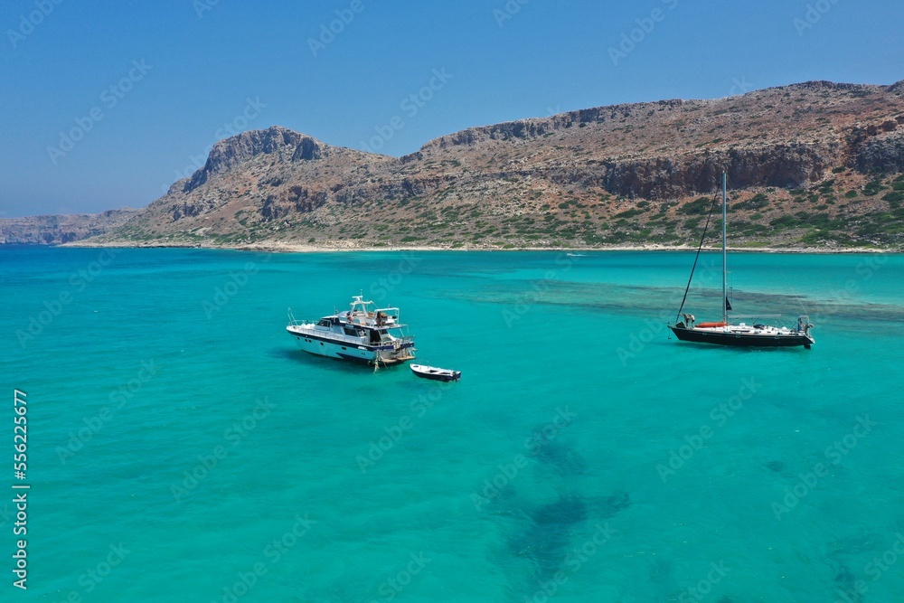 Calm blue sea on a sunny day. Yachts with turists are sailing on Libian sea .