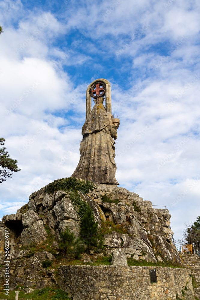 Obraz premium Baiona, Spain - December 05, 2022: sculpture dedicated to the Virgin of the Rock on a mountain near the town of Baiona, Spain