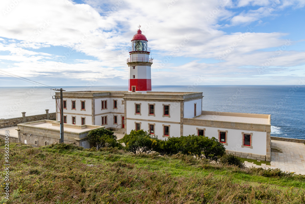 Baiona, Spain - December 05, 2022: maritime lighthouse in the atlantic ocean called faro silleiro, tourist place, in the town of Baiona, Spain Baiona, Spain - December 05, 2022: maritime lighthouse in the atlantic ocean called faro silleiro, tourist place, in the town of Baiona, Spain