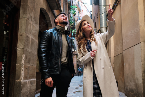 Canvas Print Couple pointing a building while visiting a city