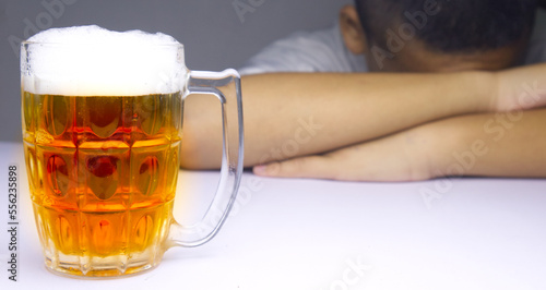 glasses of Beer and background images are male headaches. The result of excessive alcohol consumption.