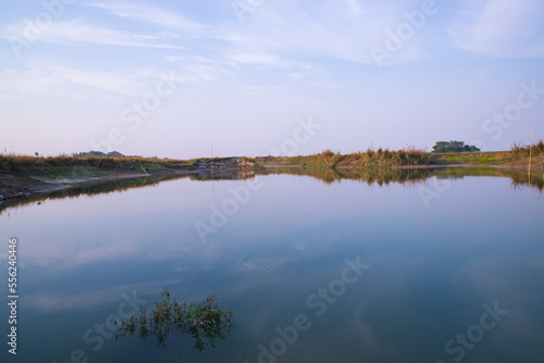 Arial View Canal with green grass and vegetation reflected in the water nearby Padma river in Bangladesh