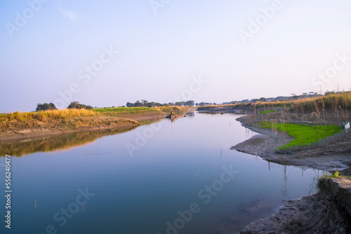 Arial View Canal with green grass and vegetation reflected in the water nearby Padma river in Bangladesh