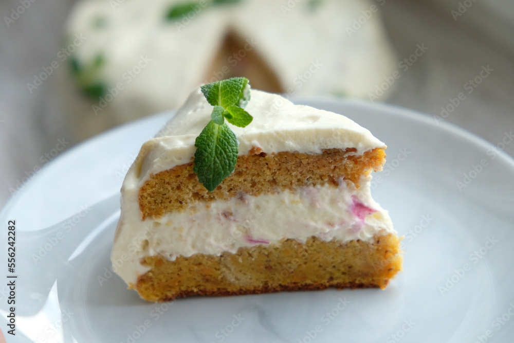 a slice of carrot cake with a mint leaf
a slice of carrot cake with a mint leaf