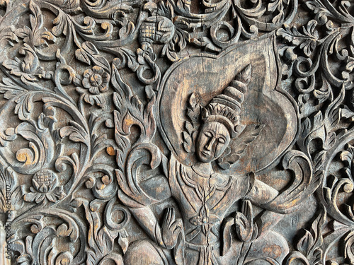 detail of a budhist theme wood carving