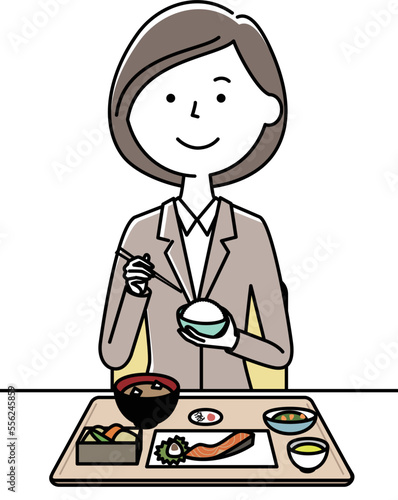 食事をするスーツの女性