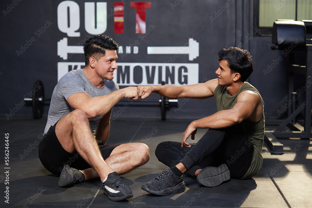 Obraz premium trainers or athletics greeting with fist after workout in the gym