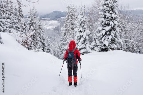 a man in the mountains on a winter hike with equipment