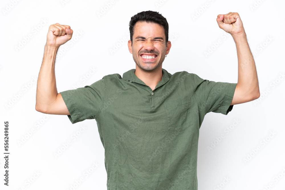 Young handsome man over isolated white background doing strong gesture Young handsome man over isolated white background doing strong gesture