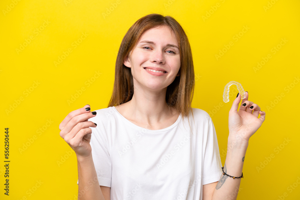 Young English woman holding invisible braces making money gesture Young English woman holding invisible braces making money gesture