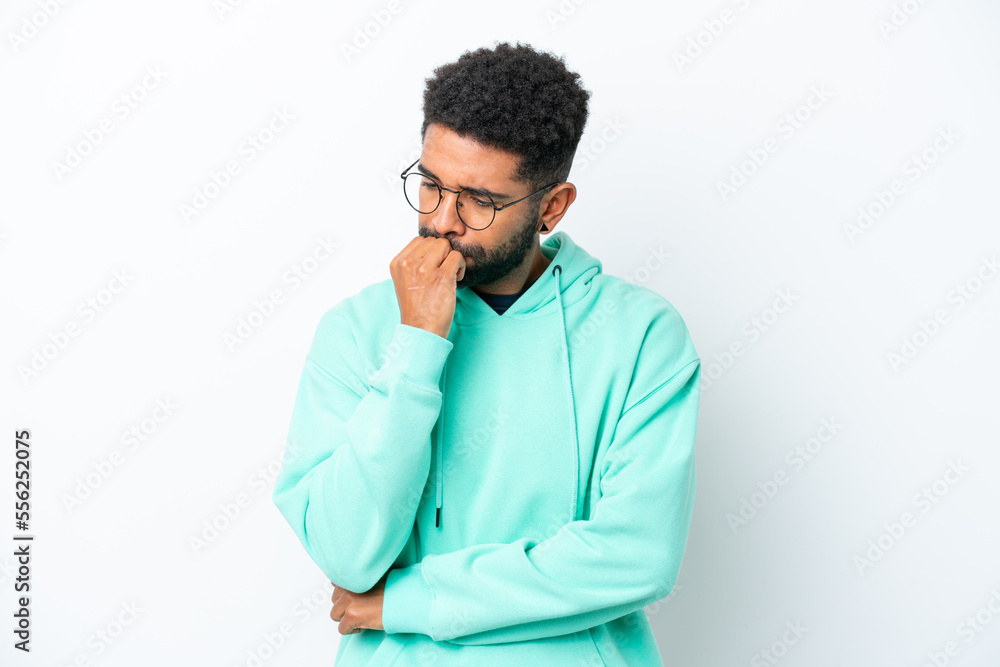 Young Brazilian man isolated on white background having doubts Young Brazilian man isolated on white background having doubts