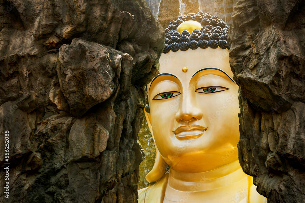 Face of Buddha, big Buddha statue is hidden behind a cliff. Important landmarks of Samut Sakhon