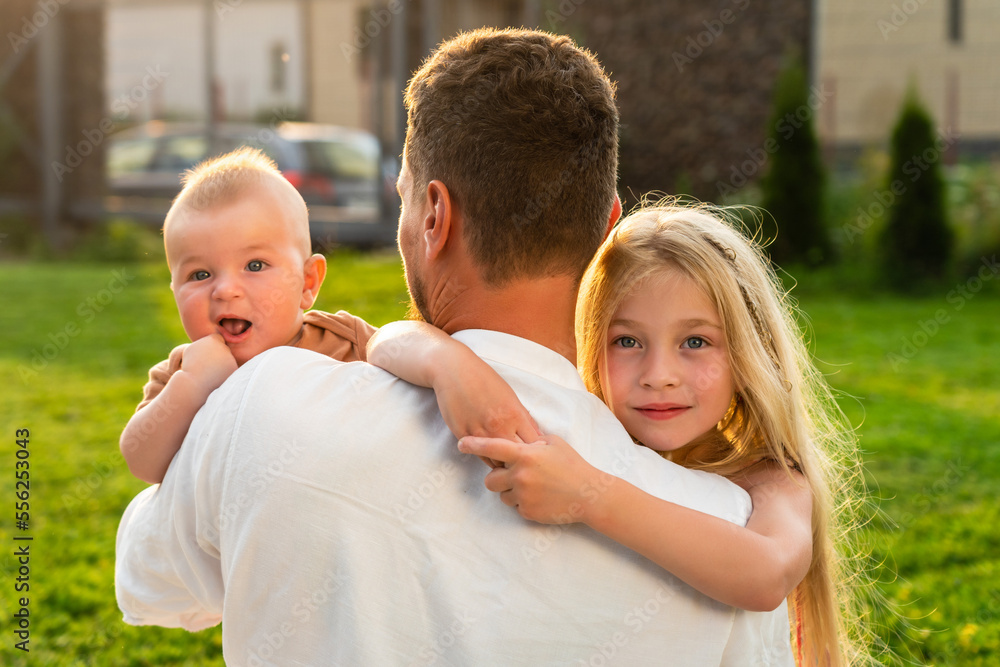 Father with happy and smiling children at summer Father with happy and smiling children at summer