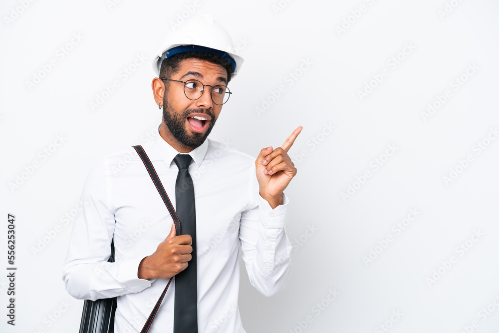 Young architect Brazilian man with helmet and holding blueprints isolated on white background intending to realizes the solution while lifting a finger up Young architect Brazilian man with helmet and holding blueprints isolated on white background intending to realizes the solution while lifting a finger up