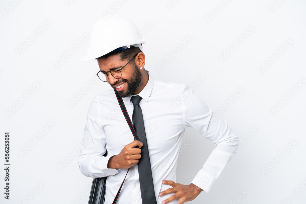 Young architect Brazilian man with helmet and holding blueprints isolated on white background suffering from backache for having made an effort Young architect Brazilian man with helmet and holding blueprints isolated on white background suffering from backache for having made an effort