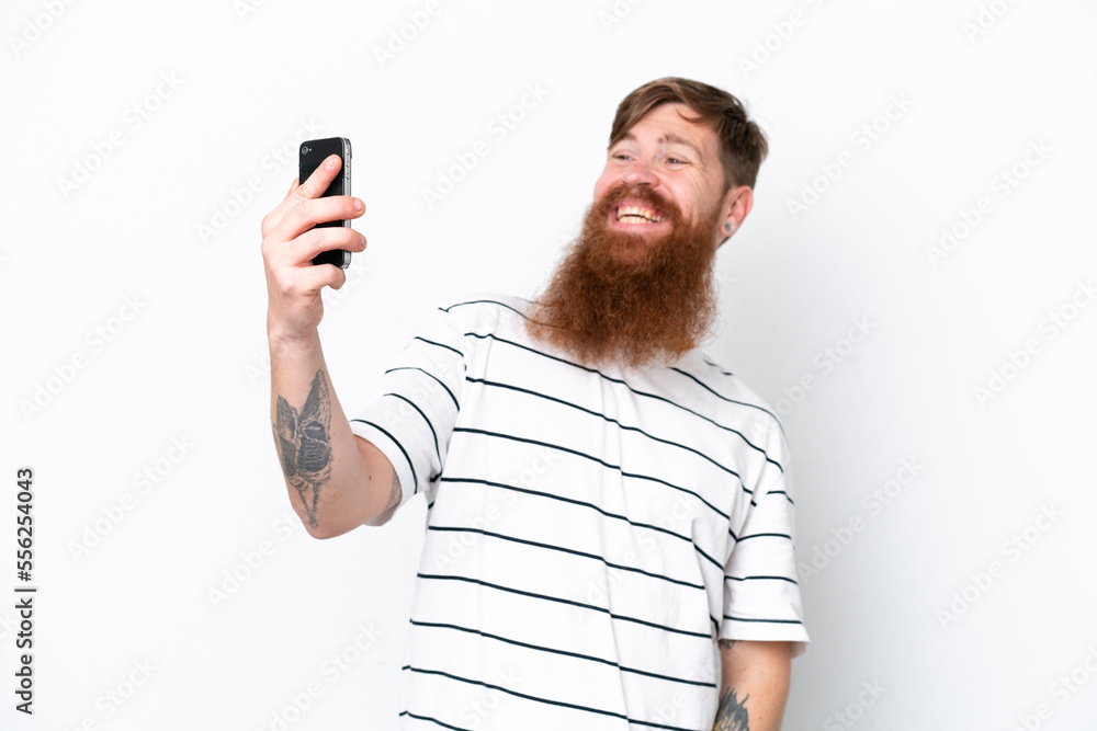 Redhead man with beard isolated on white background making a selfie Redhead man with beard isolated on white background making a selfie