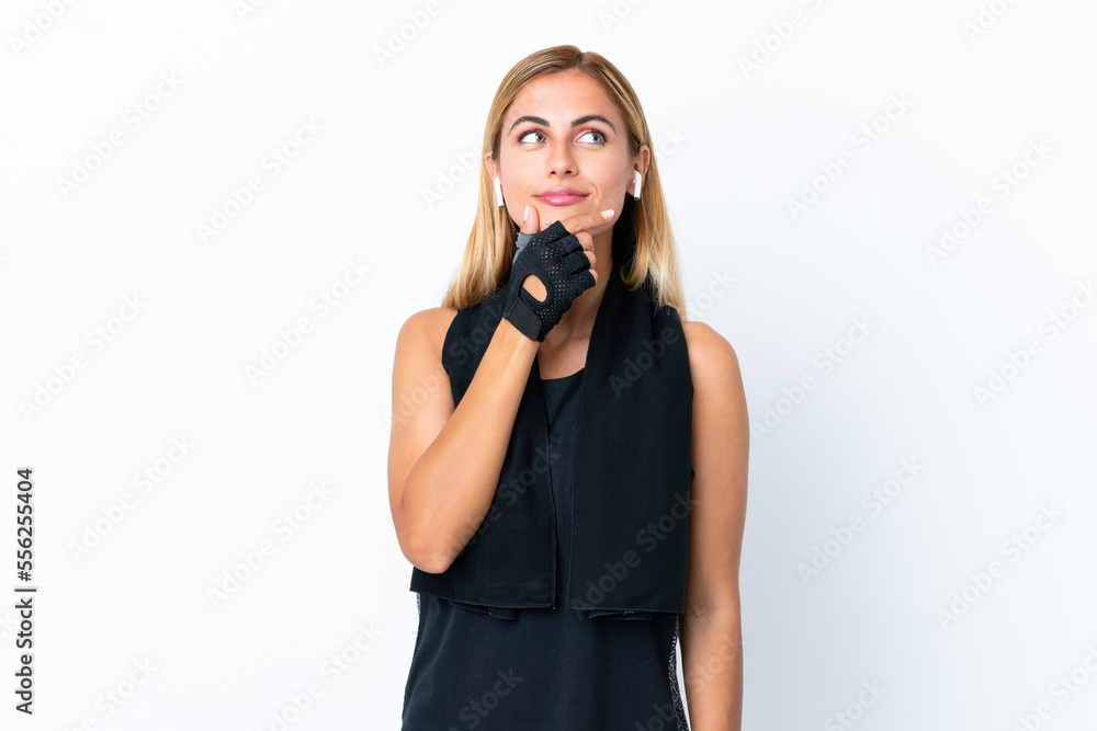 Blonde Uruguayan sport girl isolated on white background having doubts and with confuse face expression Blonde Uruguayan sport girl isolated on white background having doubts and with confuse face expression