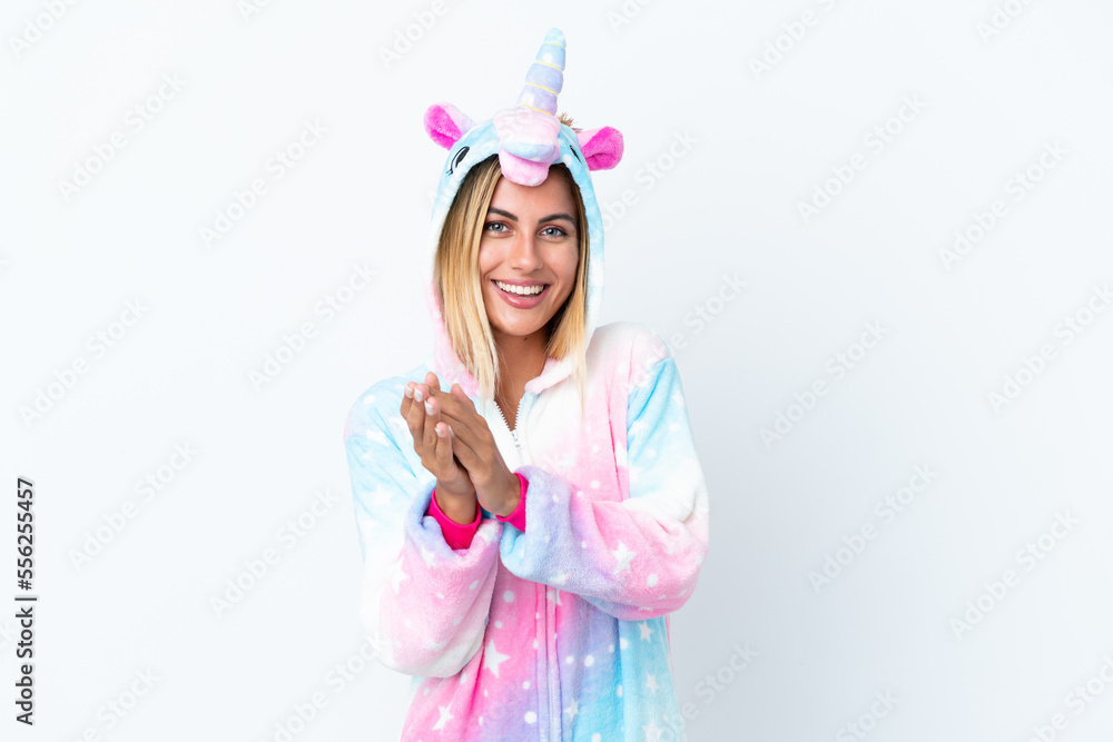 Blonde Uruguayan girl wearing a unicorn pajama isolated on white background applauding after presentation in a conference