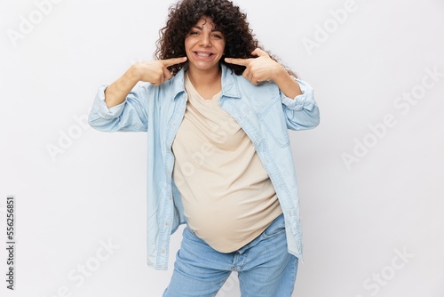 Pregnant woman smile and happiness, big belly before childbirth, Mother's Day white isolated background in T-shirt with blue shirt