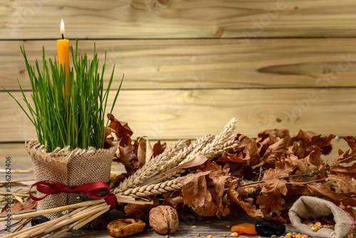 Christmas oak tree, candle, bread and dried fruits photo