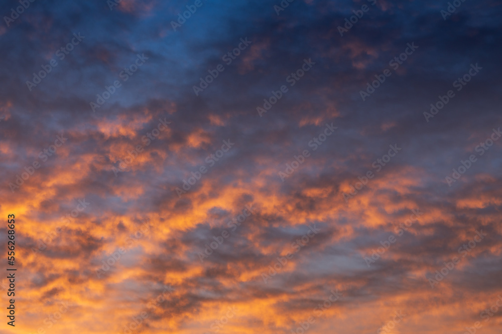 Picturesque colorful cloudscape background with light clouds in vivid sunset colors