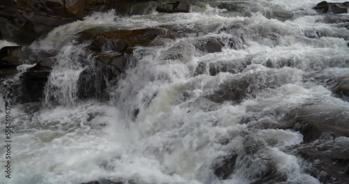 Strong flow of water due to spring flood. Cinema 4K 60fps one minute video
