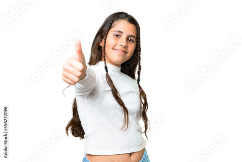 Young girl over isolated chroma key background with thumbs up because something good has happened photo