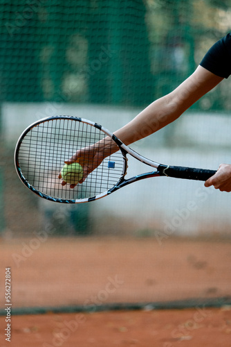 Close-up view of hand female tennis player holding ball and racket preparing to serve © fesenko