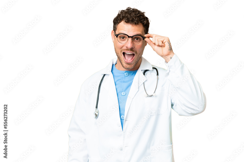 Brazilian doctor man over isolated chroma key background with glasses and surprised Brazilian doctor man over isolated chroma key background with glasses and surprised