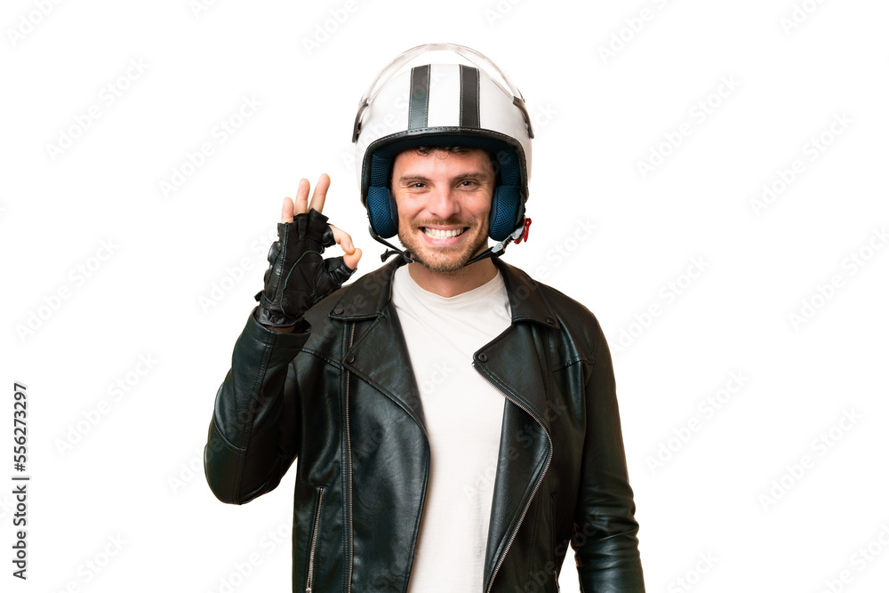 Brazilian man with a motorcycle helmet over isolated chroma key background showing ok sign with fingers Brazilian man with a motorcycle helmet over isolated chroma key background showing ok sign with fingers