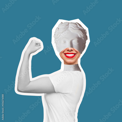 Strong smiling woman headed by antique statue with red lips raises arm and shows bicep on teal blue color background. Support women rights, feminism. Trendy collage in magazine style. Contemporary art