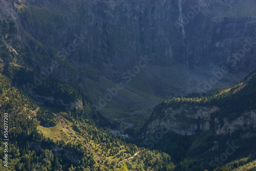 View at Cirque de Gavarnie waterfall in french Pyrenees in extreme terrain with massive rock wall formation on a sunny day, Nouvelle-Aquitaine, France