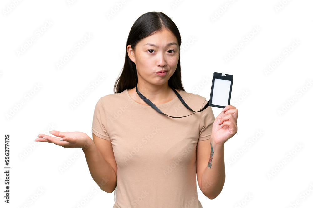 Young Asian woman with ID card over isolated background making doubts gesture while lifting the shoulders Young Asian woman with ID card over isolated background making doubts gesture while lifting the shoulders