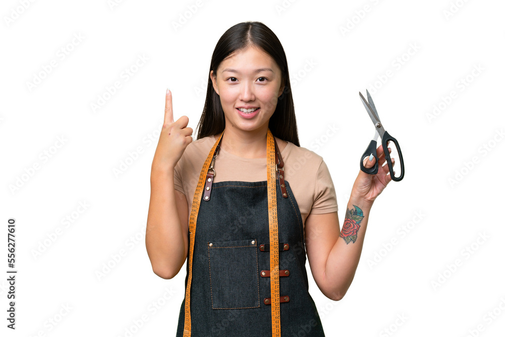 Young Asian seamstress woman over isolated background showing and lifting a finger in sign of the best Young Asian seamstress woman over isolated background showing and lifting a finger in sign of the best