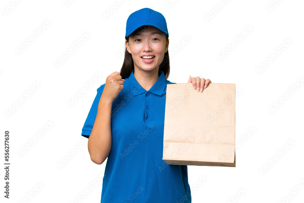 Young Asian woman taking a bag of takeaway food over isolated background celebrating a victory in winner position Young Asian woman taking a bag of takeaway food over isolated background celebrating a victory in winner position