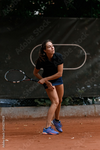 woman playing tennis and waiting tennis ball. Outdoor tennis practice.