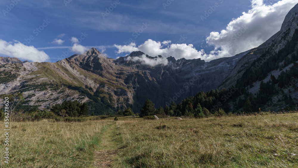 Meadow with hiking path leads to the Cirque de Gavarnie in Pyrenees Mountains, Nouvelle-Aquitaine, France