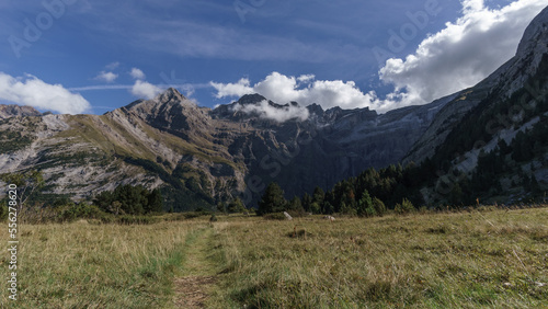 Meadow with hiking path leads to the Cirque de Gavarnie in Pyrenees Mountains, Nouvelle-Aquitaine, France